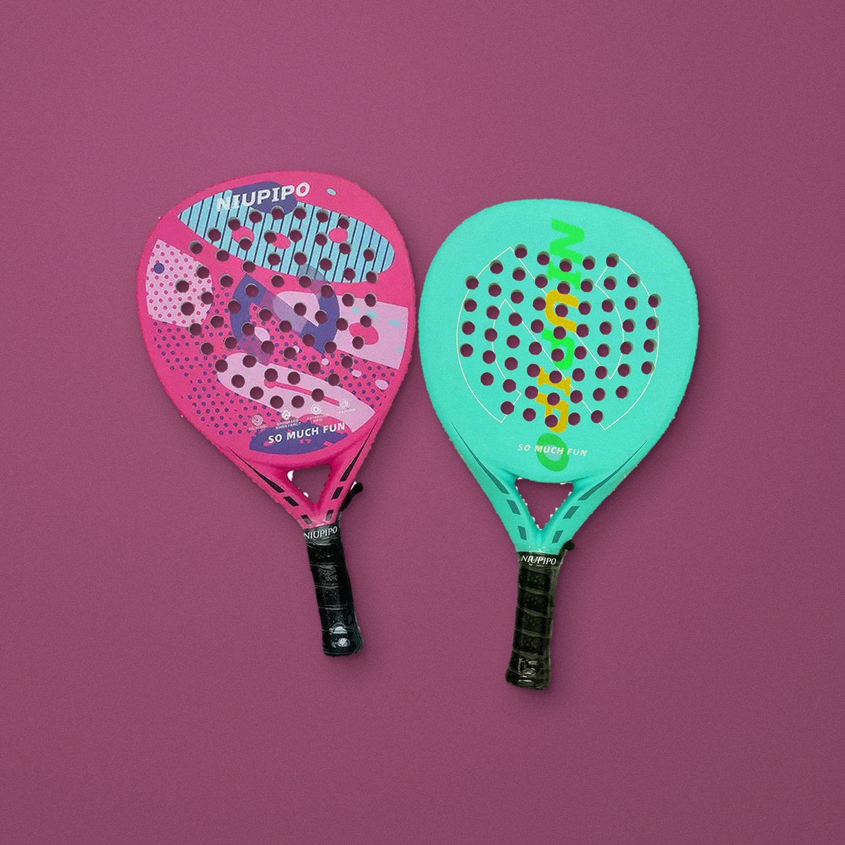 The pink and mint carbon teardrop rackets from the Couples set, laid side by side